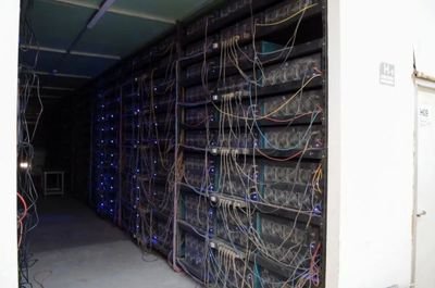 An overhead view of a sprawling mining farm in China, illustrating the scale and hidden operational challenges involved in hosting machines
